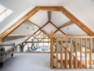 Oak frame bungalow with room in the roof. Cladded oak framed home. Oak mezzanine
